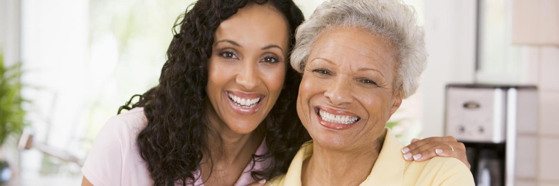 Friends smiling after getting dental implants in Aurora, IL
