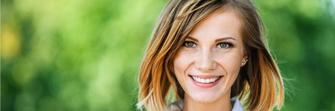 Woman smiling after dental cleaning in Aurora, IL