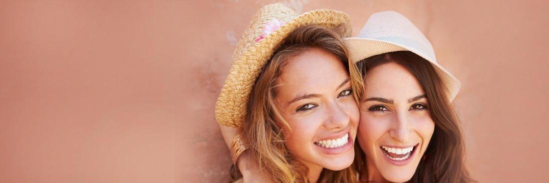 Two women smiling after dental cleaning in Aurora, IL