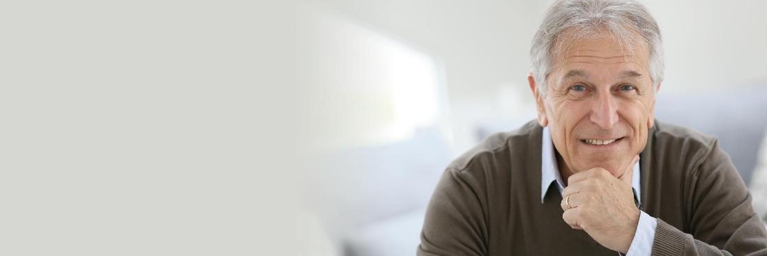 Older man smiling after getting dentures at Prairie Dental Care