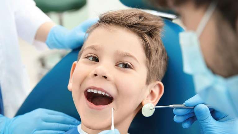 Kid undergoing dental examination and cleaning at Prairie Dental Care