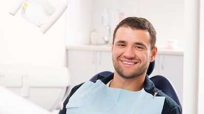 patient smiling after getting dental bridges in in Aurora, IL