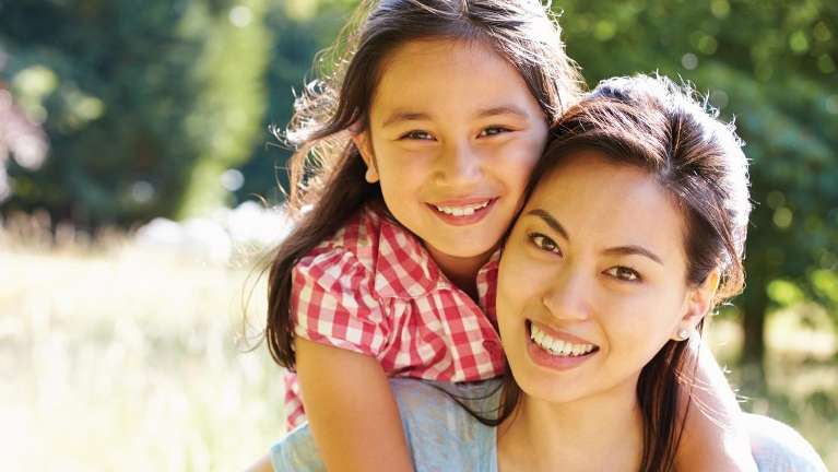 Mother and daughter smiling after general dentistry in Aurora, IL