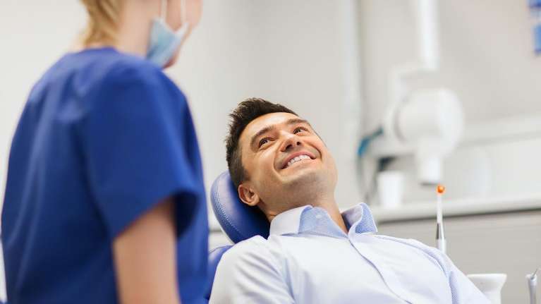 A Cantonese-Speaking patient smiling during examination at Prairie Dental Care