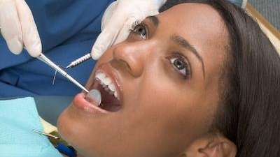 Lady undergoing teeth extraction in Aurora, IL