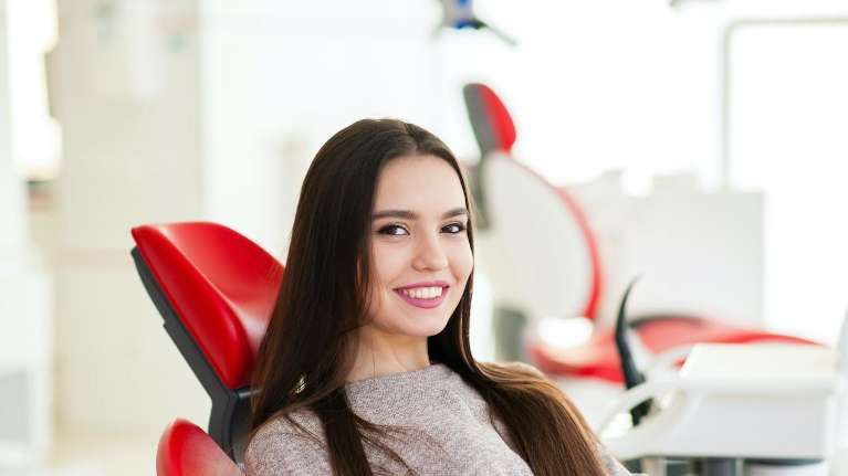 Lady relaxing on the dental chair after getting implants at Prairie Dental Care
