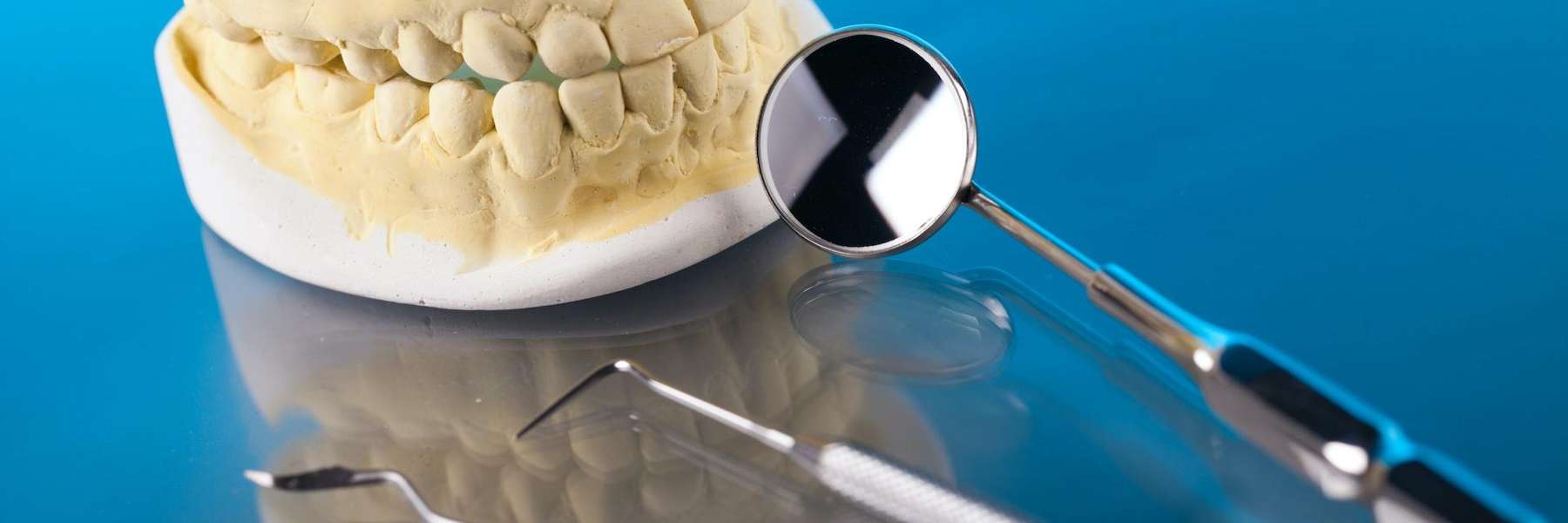A picture of a dental crown and teeth extraction tools in Aurora, IL