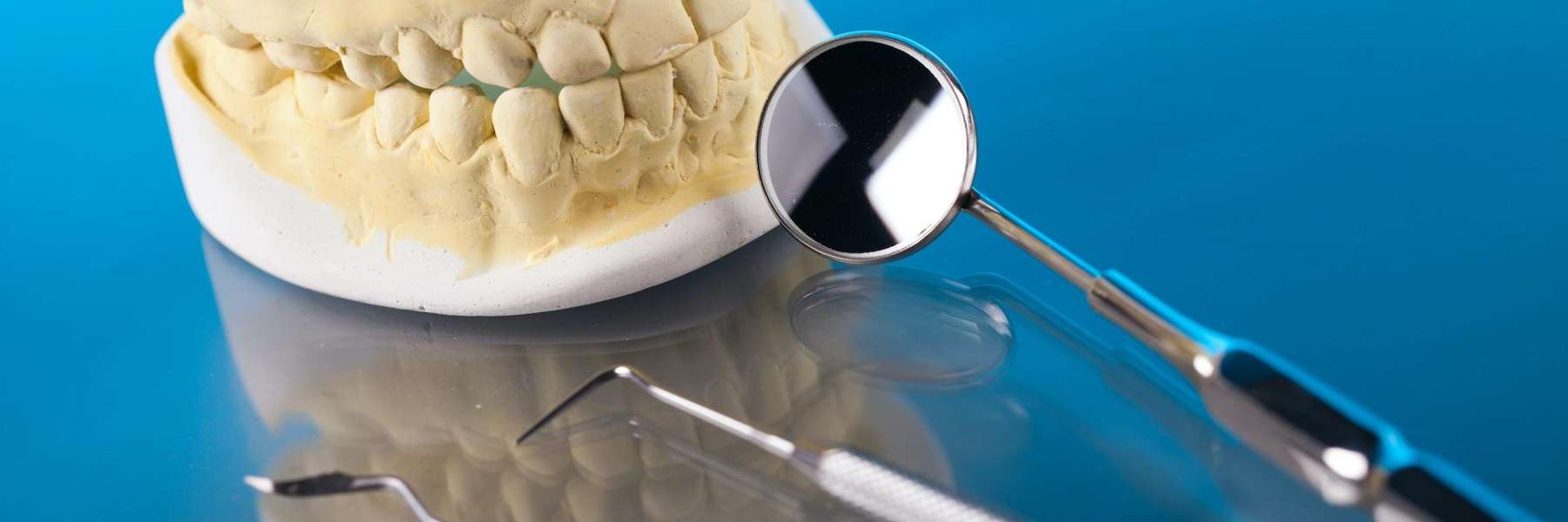 A picture of a dental crown and teeth extraction tools in Aurora, IL