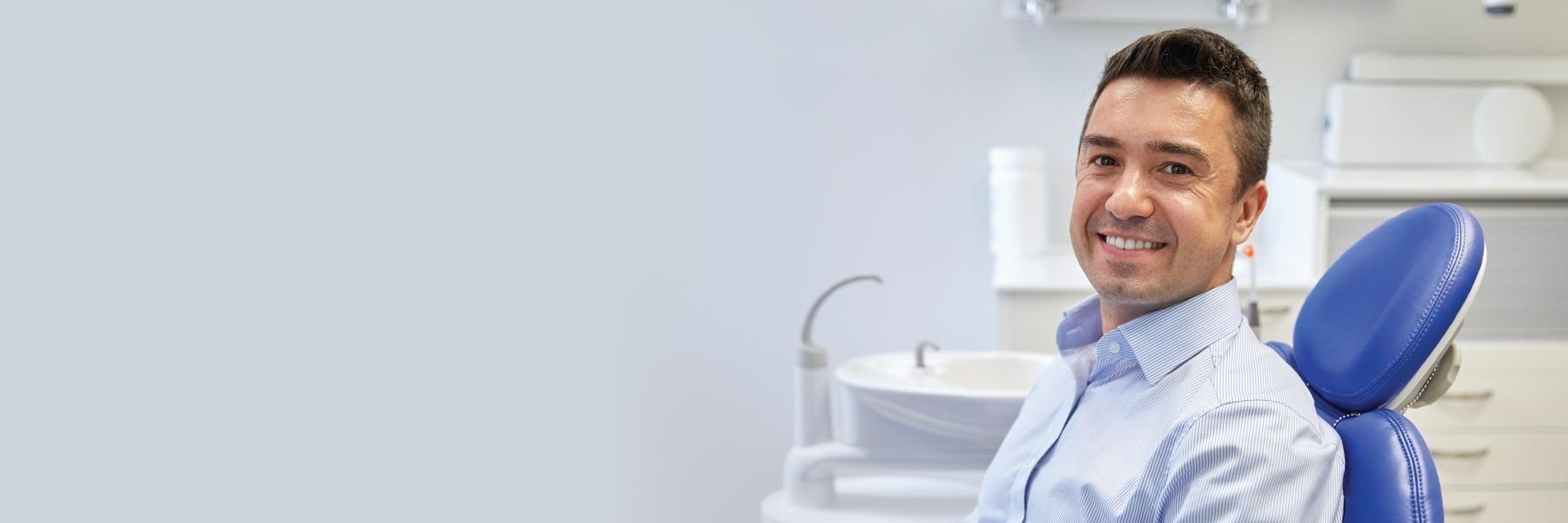 man smiling in dental chair | Dentist Aurora IL