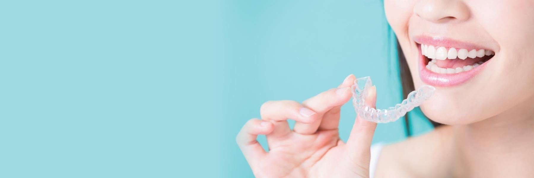 woman using invisalign | Dentist Aurora IL