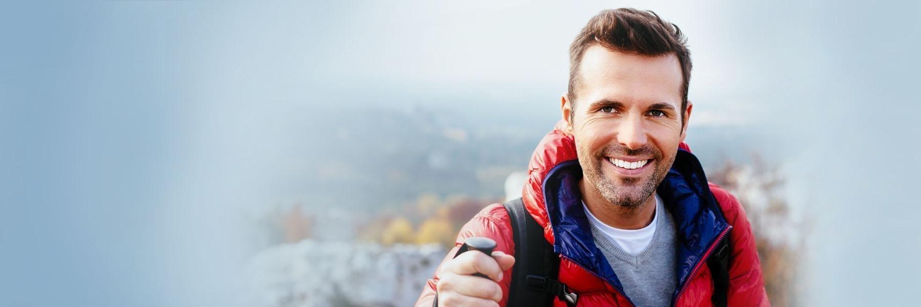 Man smiling while hiking | Dentist Aurora IL